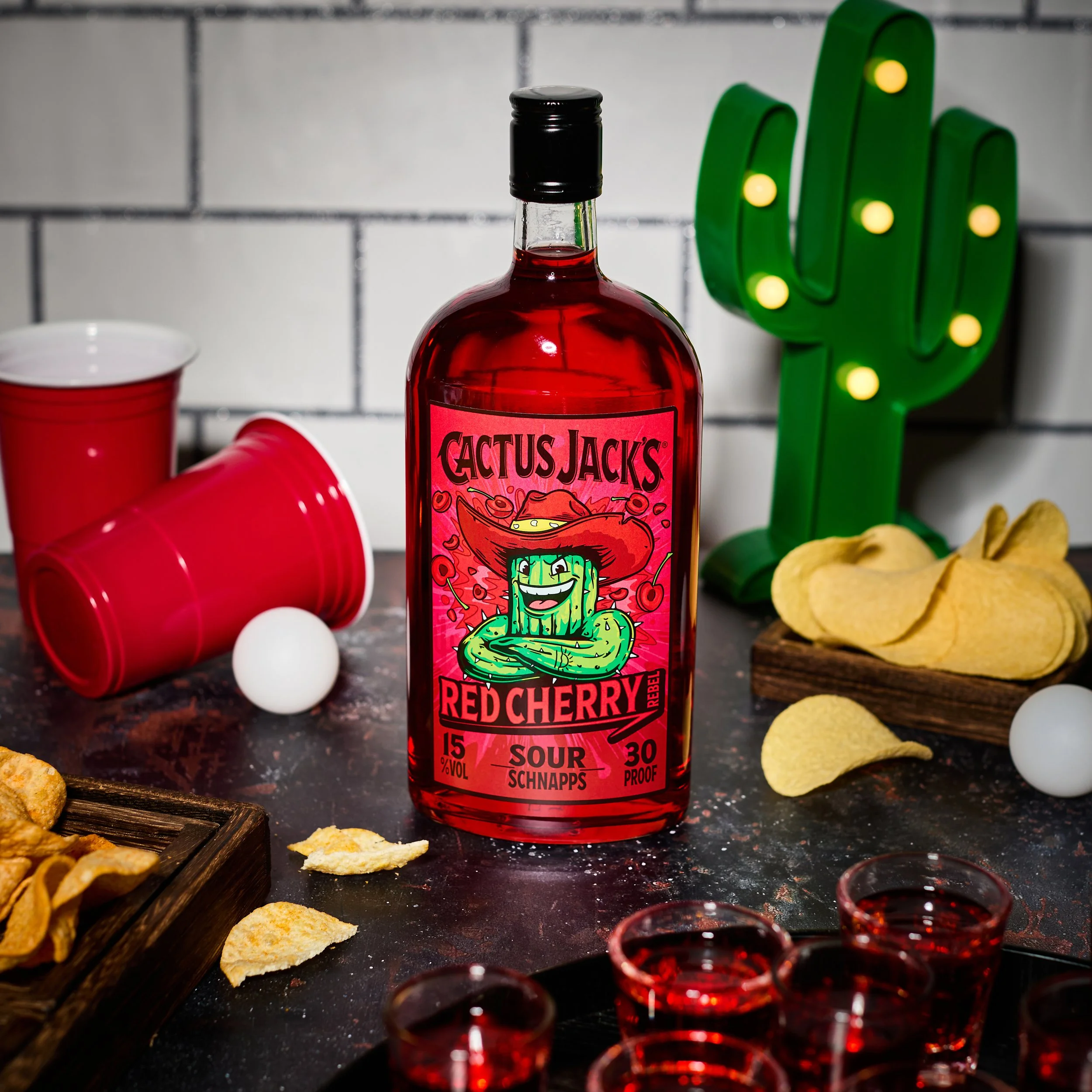 cactus jacks red cherry bottle with solo cups, ping pong ball and crisps