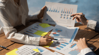 head of panel operations showing graphs and chart data as research expert
